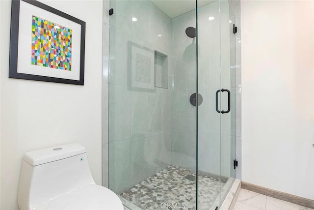full bathroom with baseboards, marble finish floor, toilet, and a shower stall