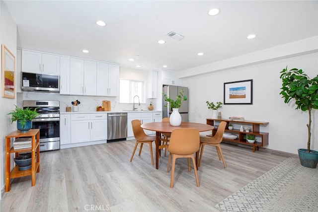dining area with baseboards, recessed lighting, light wood-style flooring, and visible vents