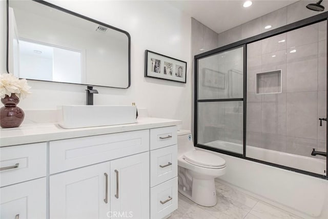 bathroom with vanity, toilet, enclosed tub / shower combo, marble finish floor, and recessed lighting