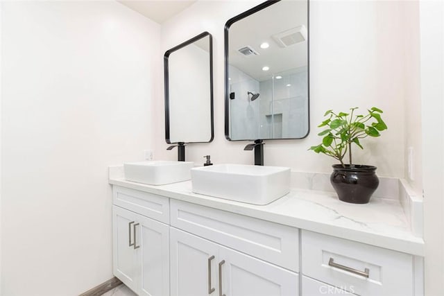 bathroom featuring a sink, double vanity, and visible vents