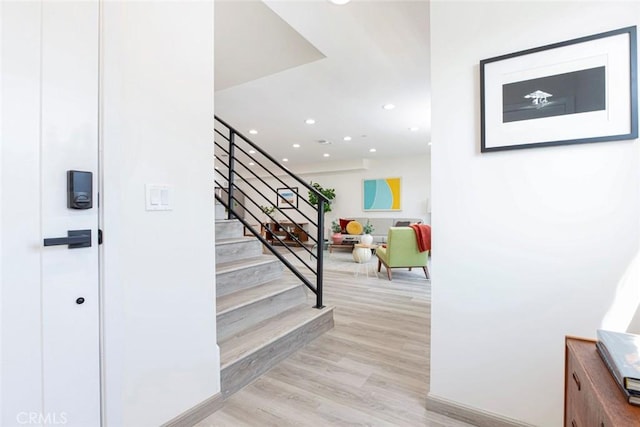 stairway featuring recessed lighting and wood finished floors
