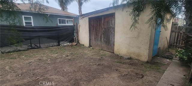 view of outdoor structure featuring fence
