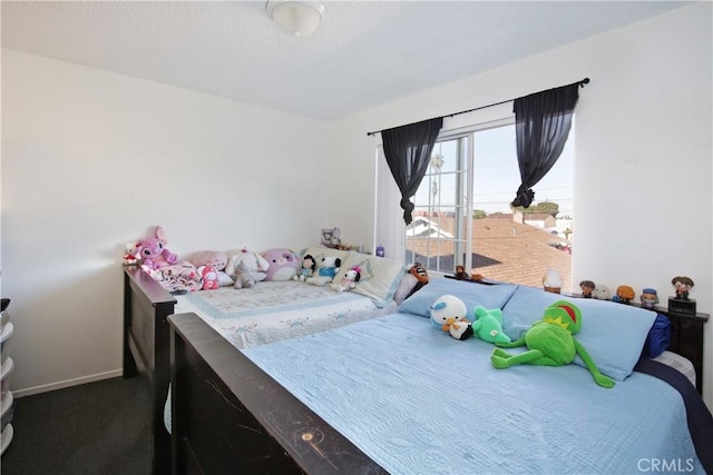 bedroom with carpet floors and baseboards