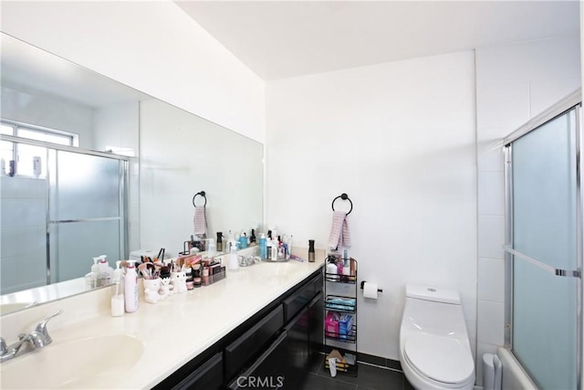 bathroom featuring toilet, double vanity, and tile patterned floors