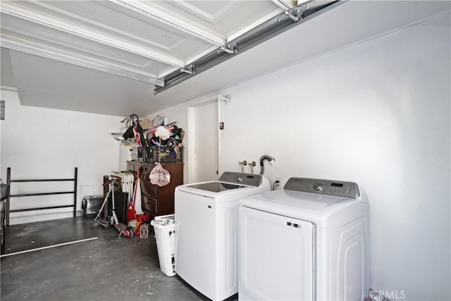 laundry area featuring washer and dryer and a garage