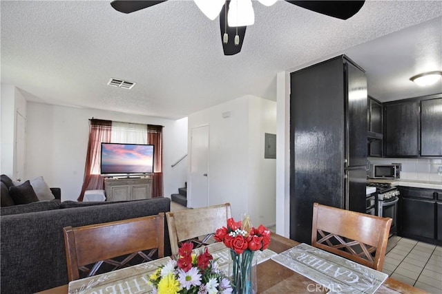 dining area with stairs, a textured ceiling, ceiling fan, and light tile patterned flooring