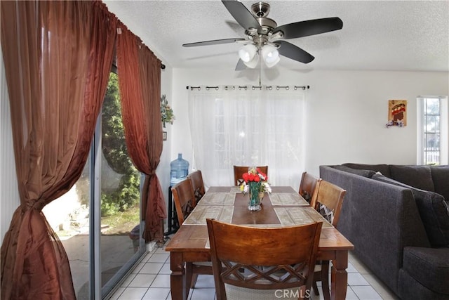 dining area with light tile patterned floors, a textured ceiling, and ceiling fan
