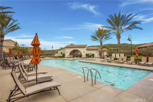 pool featuring fence and a patio area