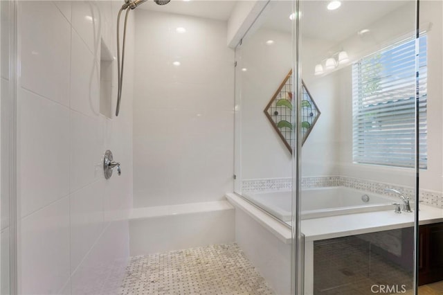 bathroom with walk in shower and a tub