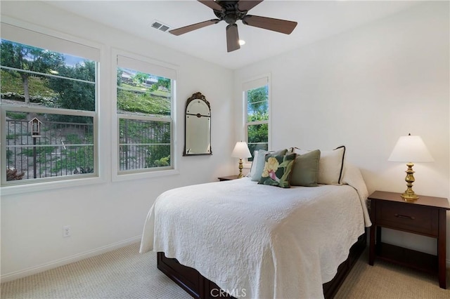 bedroom featuring carpet floors, baseboards, ceiling fan, and visible vents