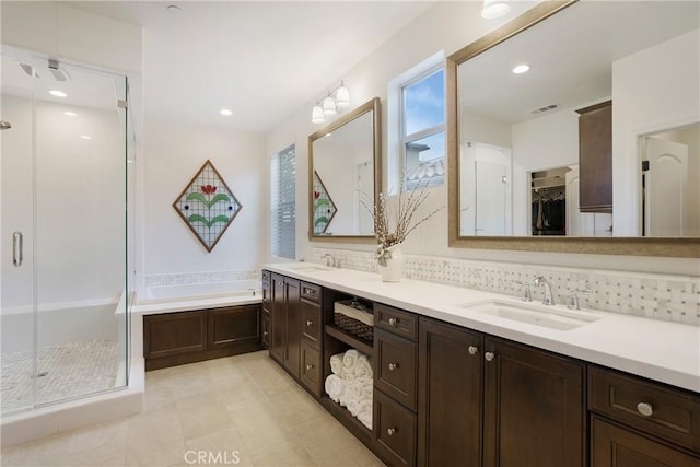 full bathroom featuring visible vents, a shower stall, a sink, and a bath
