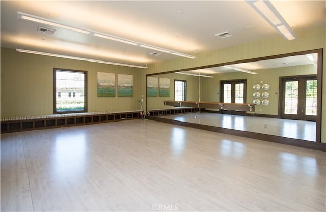 spare room featuring french doors, visible vents, and wood finished floors