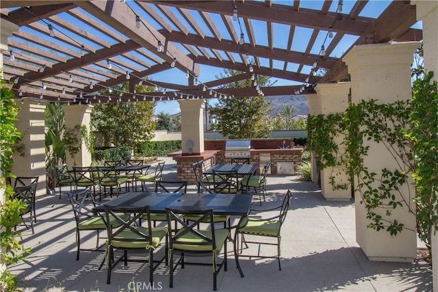 view of patio featuring outdoor dining area, a pergola, and area for grilling