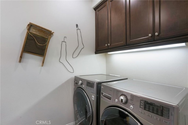 laundry room with cabinet space and washing machine and clothes dryer