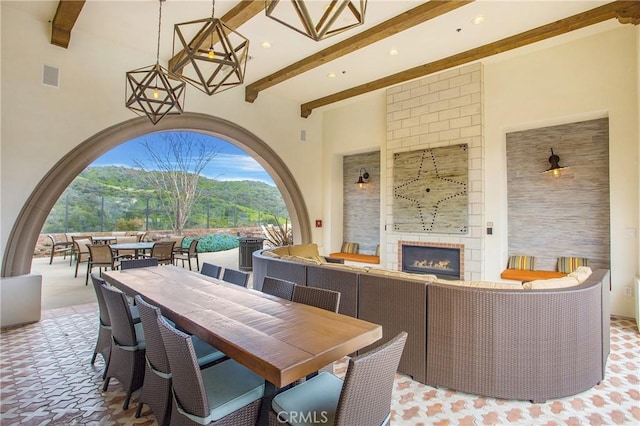 view of patio / terrace with an outdoor living space with a fireplace and outdoor dining space