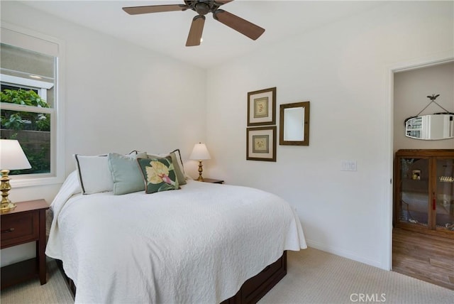 bedroom with baseboards, a ceiling fan, and carpet