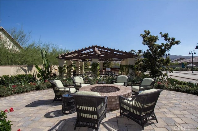 view of patio / terrace featuring a pergola, fence, and an outdoor fire pit