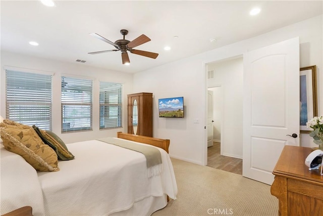 bedroom featuring recessed lighting, baseboards, visible vents, and light carpet