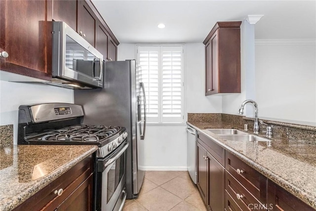 7320 Hawthorn Ave Unit 102, Los Angeles, CA 90046 - kitchen featuring stainless steel appliances, stone counters, light tile patterned flooring, dark brown cabinetry, and crown molding