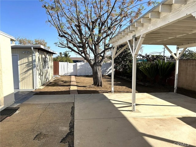 view of patio / terrace with fence and an outdoor structure