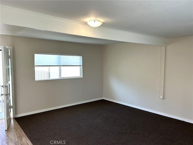 empty room with baseboards and wood finished floors
