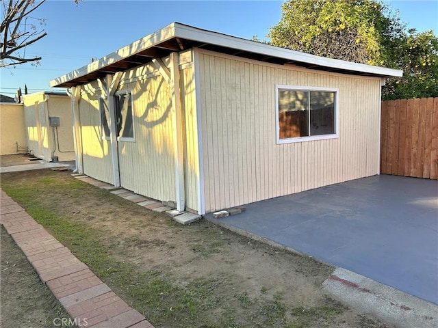 view of home's exterior with fence and a patio area