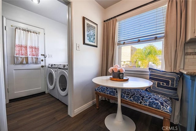 washroom featuring washing machine and clothes dryer, dark wood-style flooring, baseboards, and laundry area