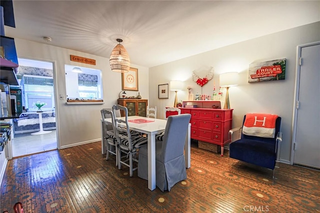 dining room with baseboards and hardwood / wood-style floors