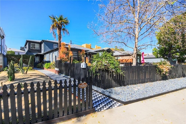 view of front of house featuring a residential view and a fenced front yard