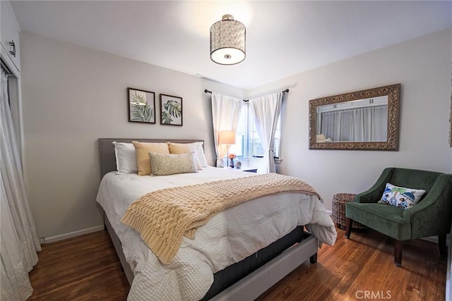 bedroom featuring baseboards and wood finished floors