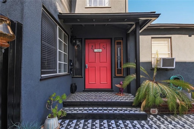 entrance to property featuring stucco siding