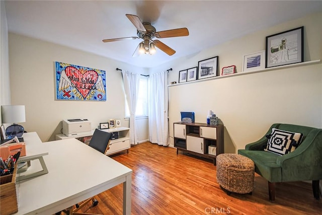 office space with a ceiling fan and wood finished floors