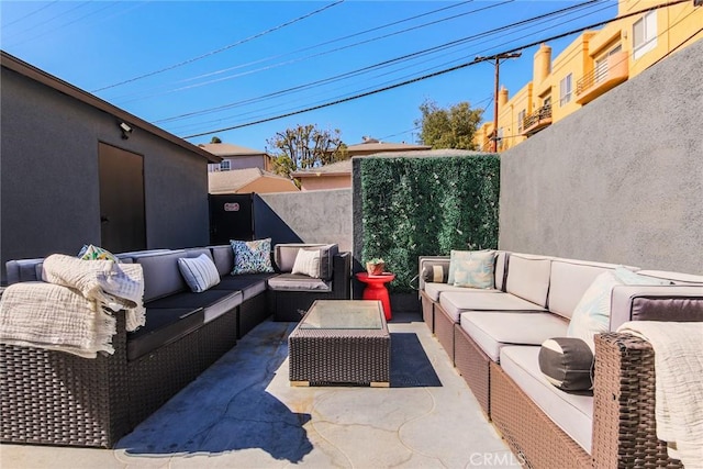 view of patio / terrace with an outdoor living space and fence