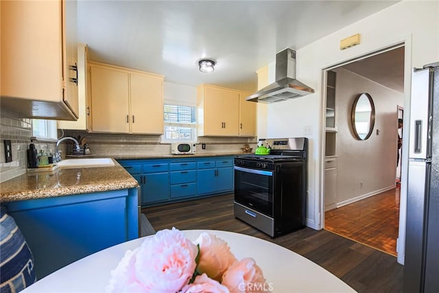 kitchen with range hood, a sink, stainless steel gas range, freestanding refrigerator, and dark wood-type flooring