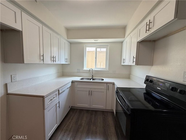 kitchen with dark wood-type flooring, light countertops, a sink, dishwasher, and black / electric stove