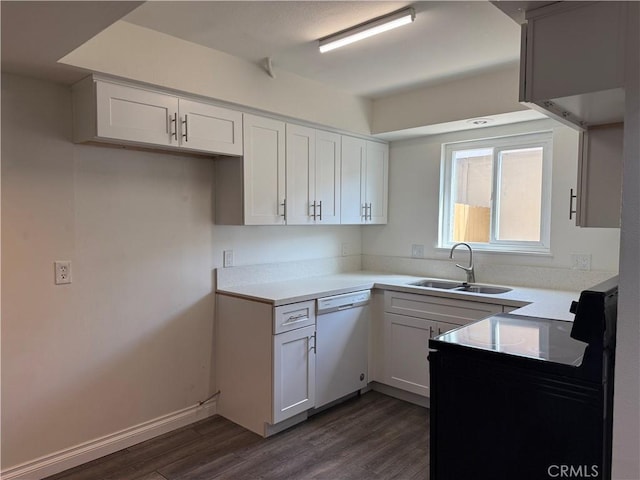 kitchen featuring a sink, light countertops, dark wood-style flooring, and dishwasher