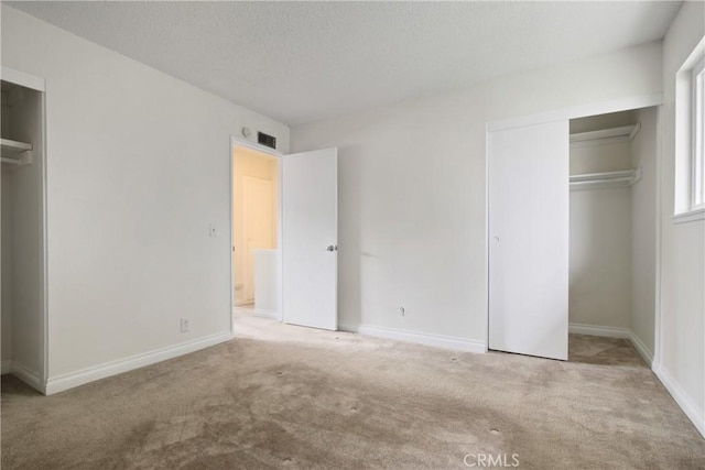 9867 Cornwall Dr, Huntington Beach, CA 92646 - unfurnished bedroom with carpet flooring, a closet, baseboards, and a textured ceiling