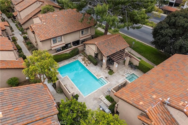 pool with a patio area and fence