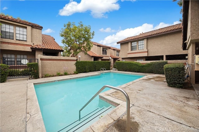pool featuring a patio and fence