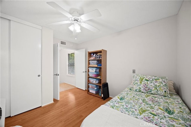 bedroom with a ceiling fan, a closet, light wood-type flooring, and visible vents
