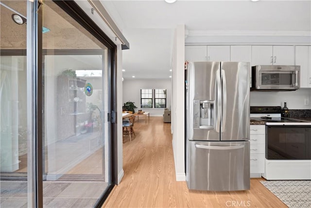 kitchen featuring dark countertops, light wood-style floors, recessed lighting, white cabinetry, and stainless steel appliances