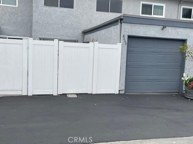 garage with visible vents and fence