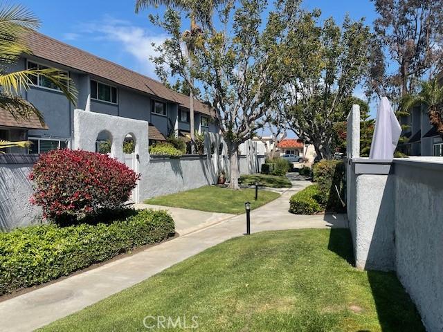surrounding community with a yard, fence, and a residential view