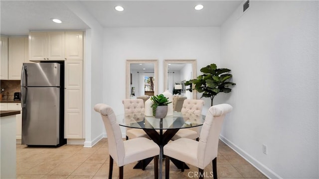 dining space with light tile patterned floors, baseboards, and recessed lighting