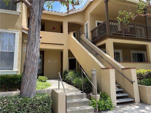 doorway to property featuring stucco siding