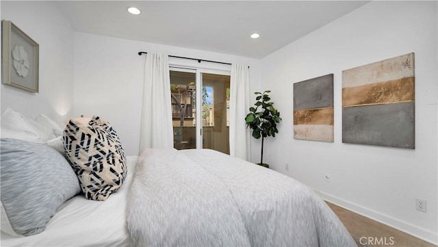 bedroom with baseboards, access to outside, and recessed lighting
