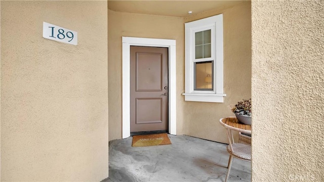property entrance featuring stucco siding