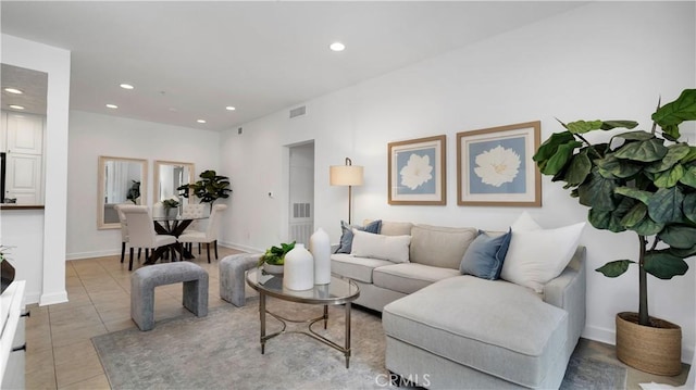 living area with light tile patterned floors, baseboards, recessed lighting, and visible vents