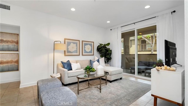 tiled living room with visible vents, recessed lighting, and baseboards
