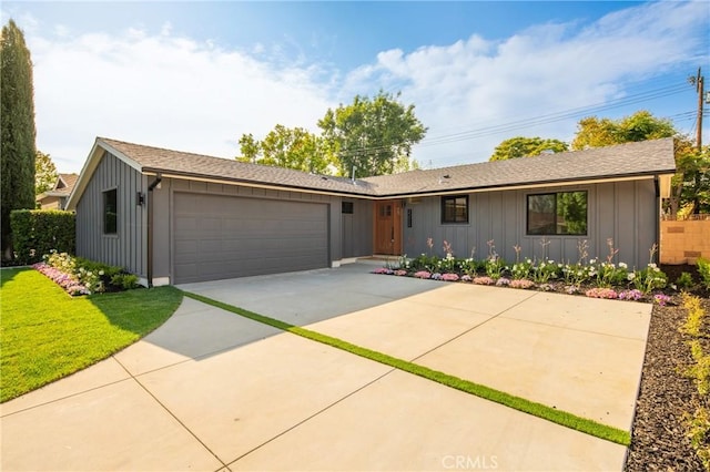23919 Friar St, Woodland Hills, CA 91367 - single story home with an attached garage, board and batten siding, driveway, a front yard, and a shingled roof